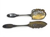 pair of antique silverware spoons on white background with white background