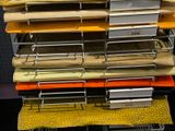 a stack of folders sitting on top of a metal rack