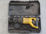 a yellow and black drill in a case on the floor