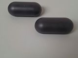 two black pills sitting on a table next to each other