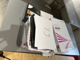 a desk with a bunch of papers and a phone on it