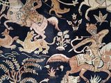 an image of a rug with animals and people on it