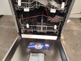 a dishwasher that is open and has a cell phone in it