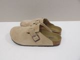 pair of beige sued clogs with buckles on the side
