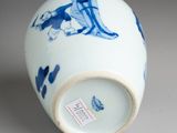 a blue and white vase with a picture of a man on a horse on it