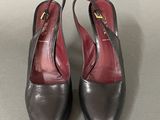 pair of women ' s black and red shoes on a gray surface