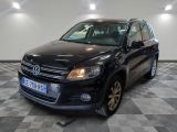the black volkswagen tiguan is parked in a large room