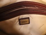 a close up of a purse with a name tag on it