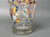 a glass cup with a floral design on it