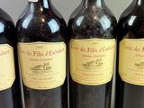 four bottles of wine are lined up on a table