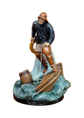 figurine of a fisherman on a boat with a net