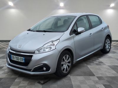 the small silver car is parked in a room with a checkered floor