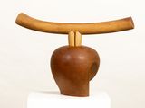 a wooden sculpture with a wooden handle on top of it