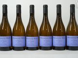 six bottles of wine are lined up in a row on a table