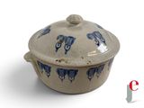 a blue and white bowl with a lid on a white surface