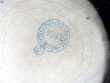 a white frisbee that has a blue stamp on it