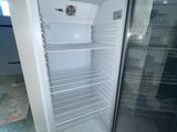 an empty refrigerator in the corner of a room