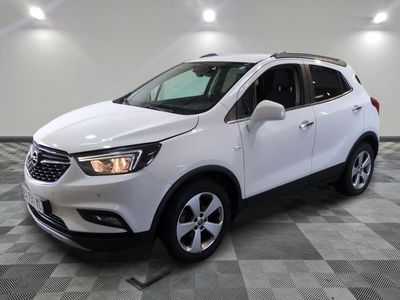 Le SUV Buick blanc est garé sur un sol carrelé à damier.