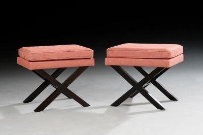 pair of pink upholstered stools with black legs
