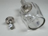 a glass bottle with a metal stopper next to it