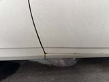 a white car that is parked on the side of the street