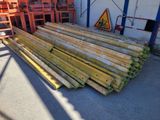several pieces of wood are stacked on top of each other in front of a building