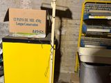 a yellow cabinet with a sign on top of it in a room