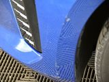 a close up of a car ' s front bumper and tire