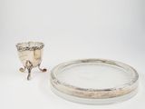 an antique silver plate with a silver cup on it and a silver plate with a silver cup on it