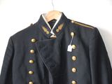 an image of a military jacket hanging on a hanger