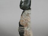 an image of a sculpture of a person with a head on a rock