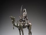 une image représentant une statue en bronze d'un homme à dos de chameau