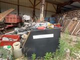 a pile of junk in a building with a roof