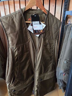 a jacket and pants hanging on a rack in a store