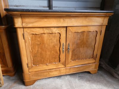 une armoire en bois posée au sol, avec un plateau en marbre