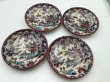 four small bowls are sitting on a white surface