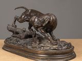 bronze sculpture of a dog chasing a cat on a log