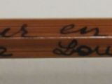 a close up of a pencil with writing on it