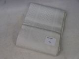 a white towel with a tag on it sitting on a table