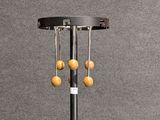an image of a floor lamp with three wooden beads hanging from it