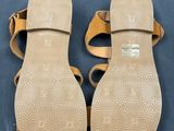 a pair of women ' s sandals on a blue surface