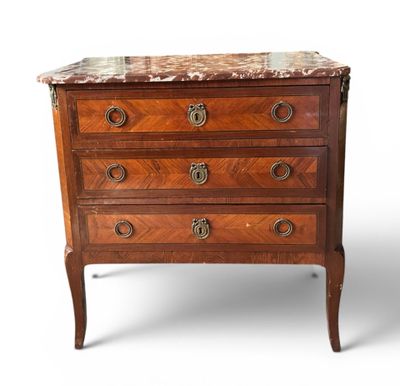 an antique chest of drawers with marble top