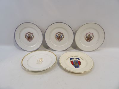 three plates with a coat of arms on them and a plate with a coat of arms on it