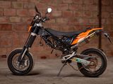 a motorcycle that is parked in front of a brick wall