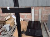 a laptop computer sitting on top of a wooden cross