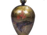 a vase that has a gold and red design on it