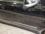 a car that has been painted black and has a broken door handle