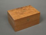 an old wooden box sitting on top of a gray surface