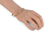 gold plated bracelet with a thin bar on the wrist