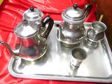 a silver tray with a silver tea set on it